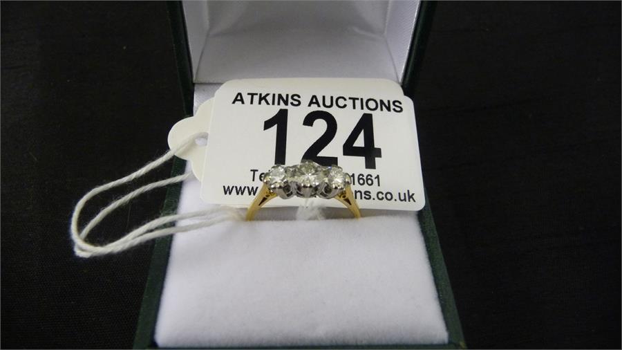 A good diamond three stone ring set in 18ct yellow gold ( hallmark worn)