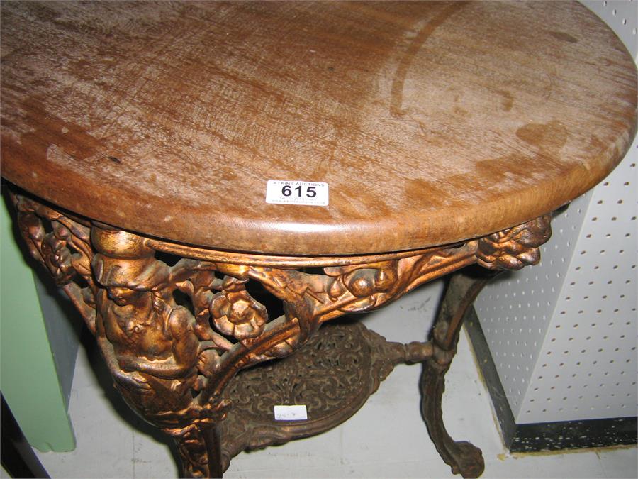 A cast iron Brittania pub table with circular top