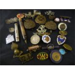 A quantity of various badges, brooches etc.