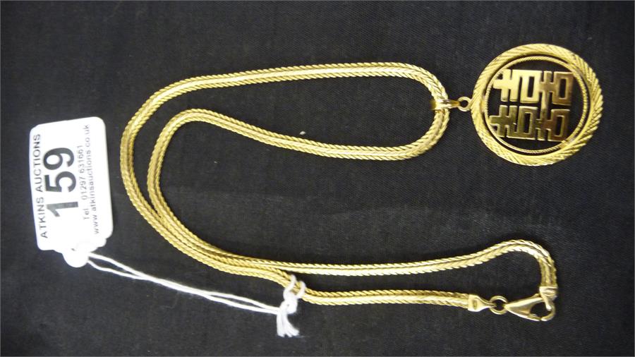 A high carat medallion ( 5.26g) on an 18ct gold chain ( 14.1g)