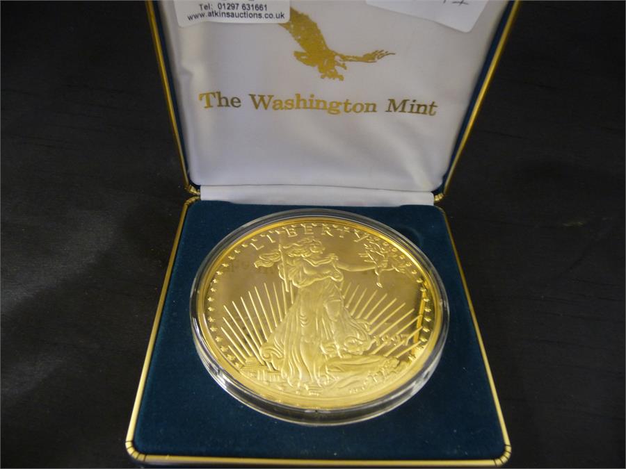 A giant half pound "Golden Eagle" proof coin by the Washington Mint- Pure Silver which is layered