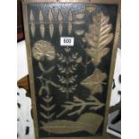 An Arts & Crafts brass panel of various leaves etc.