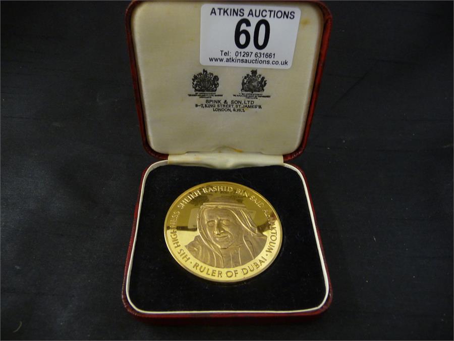 A Dubai commemorative coin "Dubai Inter Continental 1975" in original case from Spink & Sons
