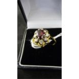 A garnet and diamond cluster set in 18ct gold