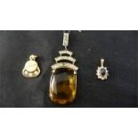 A 10 ct gold pendant set with 3 small diamonds and two others