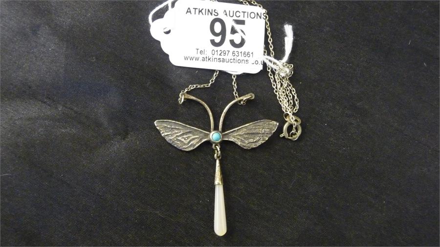 A 925 silver pendant in the form of a butterfly set with turquoise and a large drop mother of