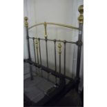 A single brass and iron bed