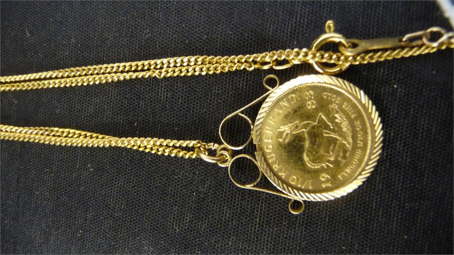 A 1/10th Krugerrand set in a 9ct gold mount with matching chain -total weight 7.19g