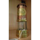 A brass and copper miners lamp by the British Coal Mining Company, Wales UK, from the Aberaman