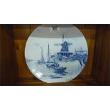 A Delft plate of typical dutch scene signed L Apol ( Louis Apol 1850-1936)