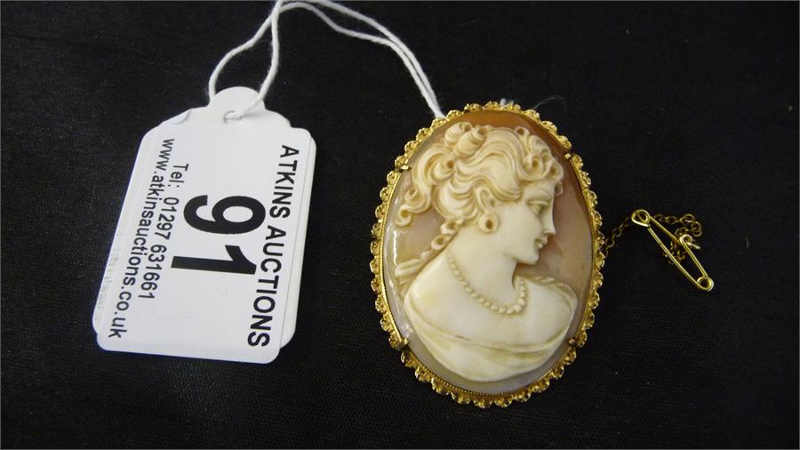 A cameo set in 18ct gold mount with safety chain and option to hang as a pendant