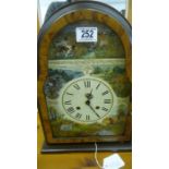 A modern mantle clock decorated with wildlife scenes- key in office