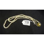 A double string of cultured pearls on a clasp ( reverse marked 14 K)