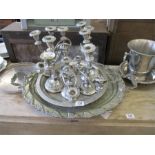 A large silver plated oval two handled tray with a quantity of silver plated candelabra etc.