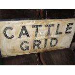 A vintage cattle grid sign