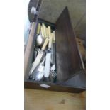 A wooden cutlery box containing various silver plated cutlery