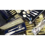 A quantity of silver plated cutlery including servers with ornate handles