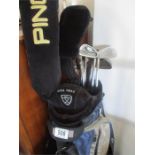 A set of Ping golf clubs in bag