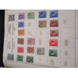 A stamp album along with loose stamps