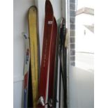 A quantity of vintage skis and poles