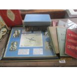 A box of various books, mainly military related along with a framed picture of German aces