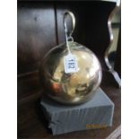 A 19th century bell metal sphere with hanging fixtures