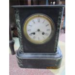 A slate mantle clock with white enamel dial