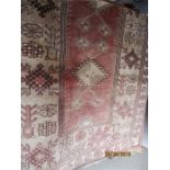 A beige rug with geometric patterns 41 inches x 76 inches approx