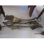 A quantity of brass and iron fire irons etc.