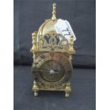 A small battery operated brass lantern clock