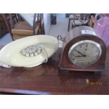 A Temco electric clock (glass cracked) along with a vintage telephone