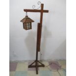 An adjustable oak standard lamp in the form of a lantern