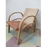 An Art Deco 1930's easy chair with wooden arms