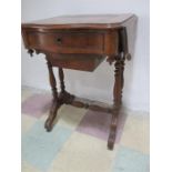 A Victorian sewing table with drop down flaps