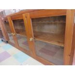 A modern pine glazed display cabinet