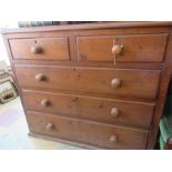 A stained pine chest of drawers