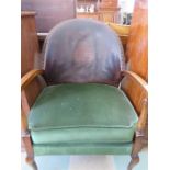 An oak framed armchair with leather back