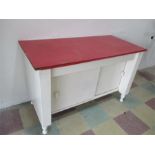 A wooden dresser base with sliding doors, Formica top A/F