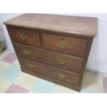 A stained pine chest of four drawers