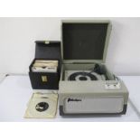 A Portadyna record player along with a quantity of 45's