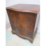 A small serpentine chest of drawers