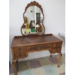 A walnut veneered dressing table on cabriole legs