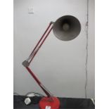 A red anglepoise style lamp