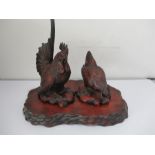 A 20th century Oriental lacquer cockerel and chicken on stand