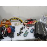 A quantity of Scaletrix including cars, track, buildings/barriers, controllers etc and 2 boxes of