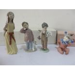 A Lladro figure of a lady holding a hat and 3 Nao figures of boy dressed as clown, boy with football