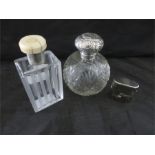 A silver topped scent bottle, an Art Deco ivory topped scent bottle with silver mount and a