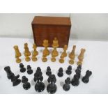 A wooden chess set in mahogany box ( pawn missing and also base of knight)