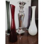 Four glass vases and a silvered candlestick