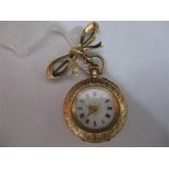 A 14 ct gold fob watch ( case marked D F & C) attached to a 9 ct gold bow